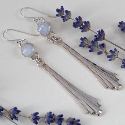 Handmade sterling silver dangle earrings featuring fan-shaped cascading drops and round moonstone gems, with minimalist artisan design and elegant movement.