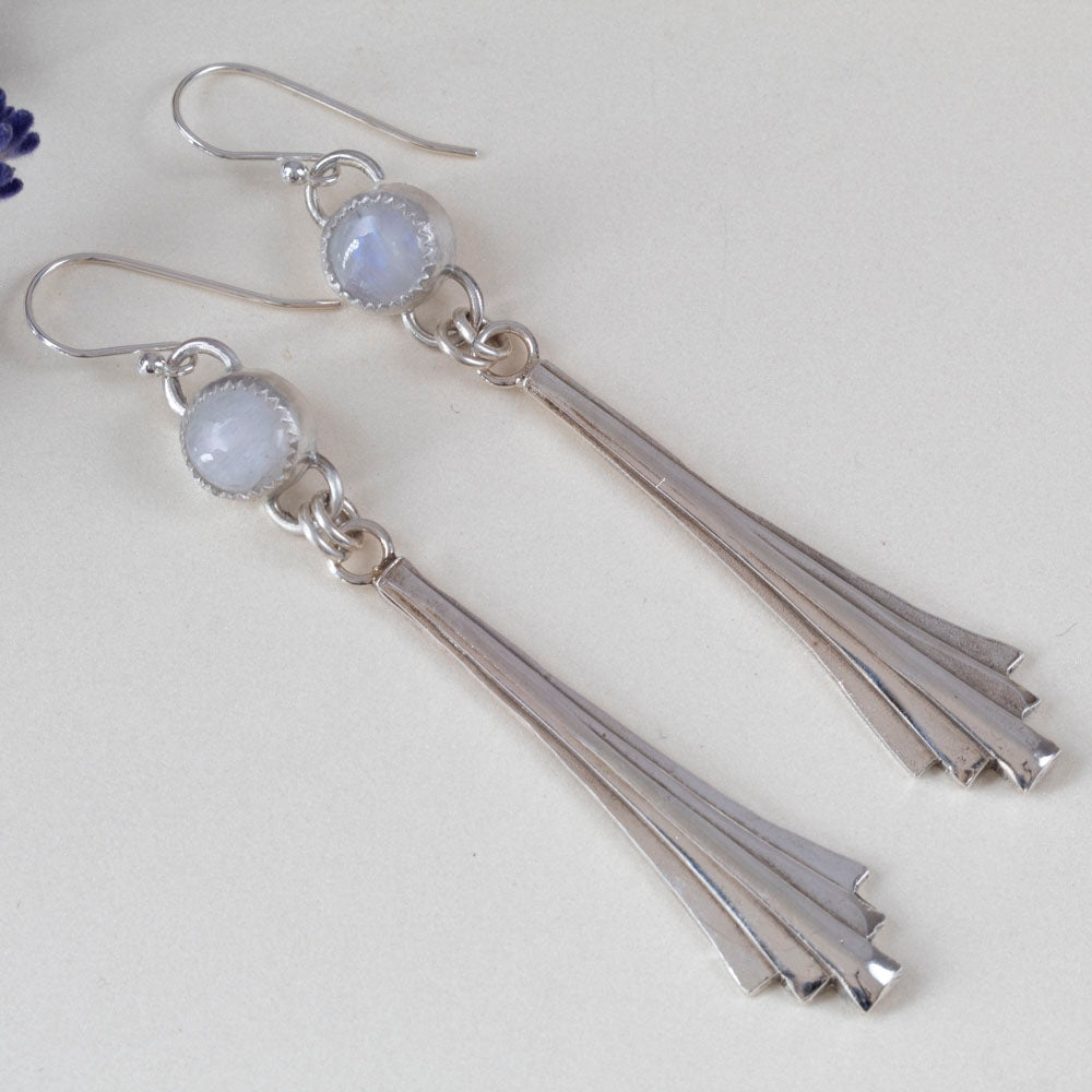Handmade sterling silver dangle earrings featuring fan-shaped cascading drops and round moonstone gems, with minimalist artisan design and elegant movement.