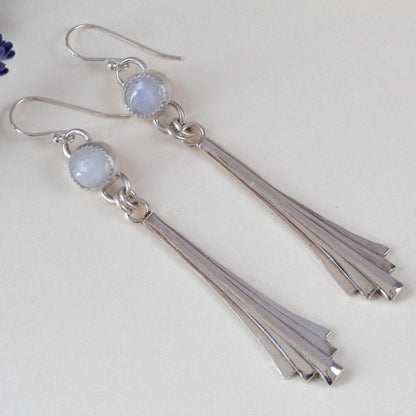 Handmade sterling silver dangle earrings featuring fan-shaped cascading drops and round moonstone gems, with minimalist artisan design and elegant movement.