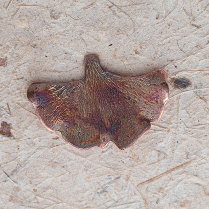 Handcrafted copper ginkgo leaf brooch with textured detail and organic fan shape, featuring nature-inspired botanical design and warm earthy patina.