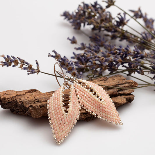 Handwoven beaded earrings in a delicate leaf shape, featuring seed beads and metallic accents, handmade by Divella Designs.