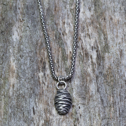 Solid sterling silver pine cone pendant on oxidized bead chain.