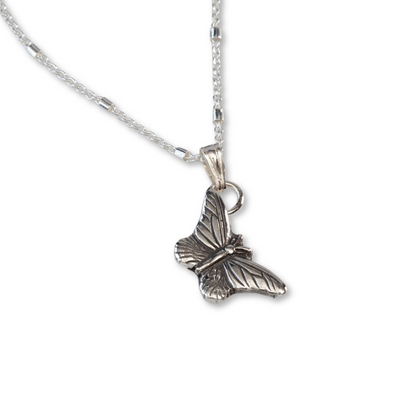 Delicate sterling silver butterfly pendant necklace with fine wing detailing, displayed on a white background.