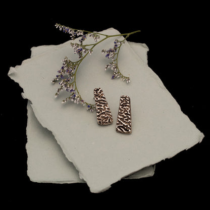 Handmade fine silver stud earrings with textured tree bark pattern, featuring trapezoid shape and rustic organic design for nature-inspired artisan styl