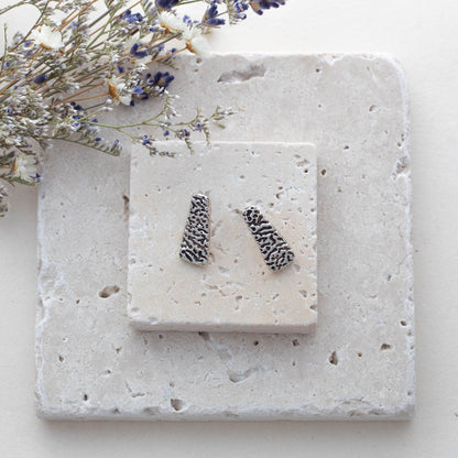Handmade fine silver stud earrings with textured tree bark pattern, featuring trapezoid shape and rustic organic design for nature-inspired artisan styl