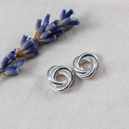 Sterling silver knot earrings with a bright polished finish. Simple, sculpted, and handmade in Vermont — the perfect everyday pair.