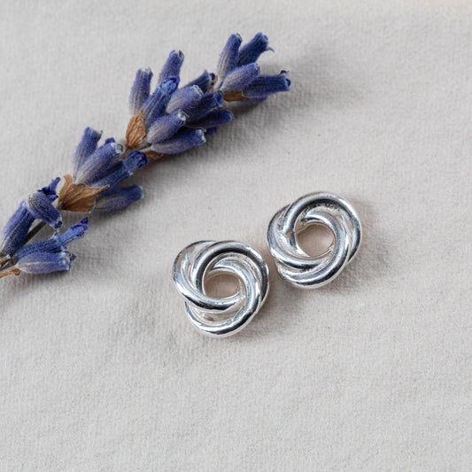 Sterling silver knot earrings with a bright polished finish. Simple, sculpted, and handmade in Vermont — the perfect everyday pair.