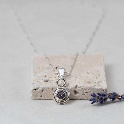 Sterling silver pendant necklace with simulated alexandrite that shifts from greenish-blue to deep violet, handmade in Vermont by Divella Designs.