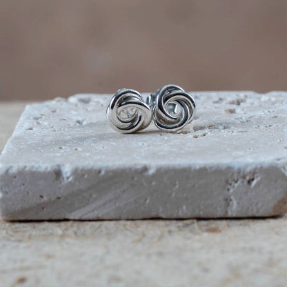 Sterling silver knot earrings with a bright polished finish. Simple, sculpted, and handmade in Vermont — the perfect everyday pair.