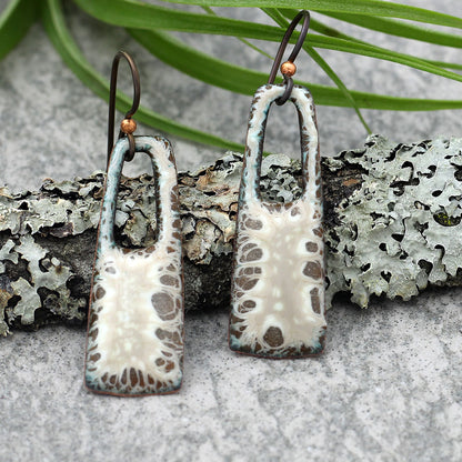 Cream and brown enamel earrings with open arch design and niobium ear wires