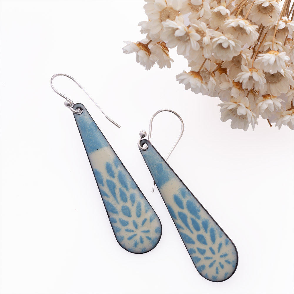 Blue and ivory rectangle earrings with floral pattern handmade in Vermont with kiln-fired enamel on copper and sterling silver ear wires.
