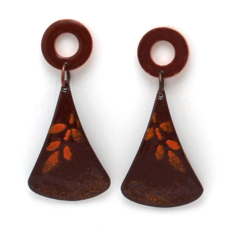 Rusty red enamel dangle earrings with circular copper studs and flared triangular drops, featuring a subtle golden leaf pattern.