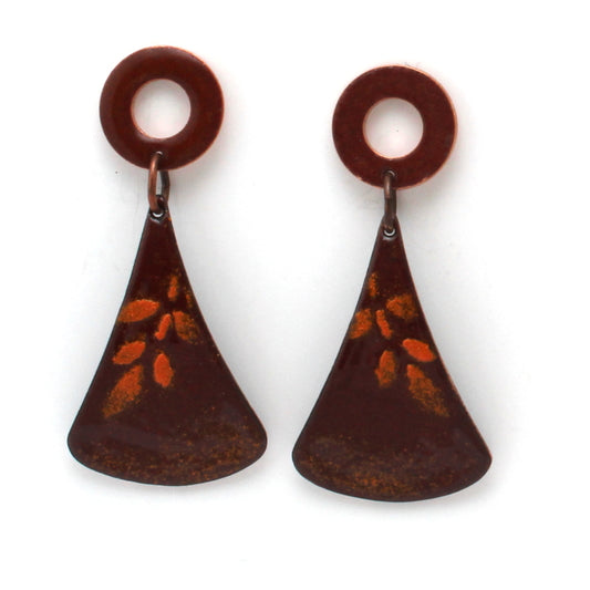 Rusty red enamel dangle earrings with circular copper studs and flared triangular drops, featuring a subtle golden leaf pattern.