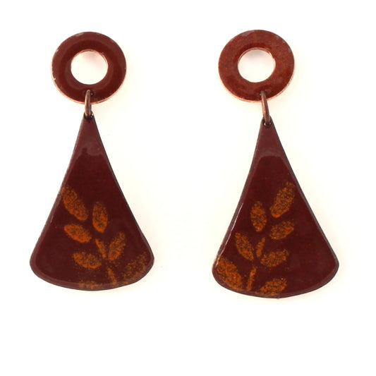 Rusty red enamel dangle earrings with circular copper studs and flared triangular drops, featuring a subtle golden leaf pattern.