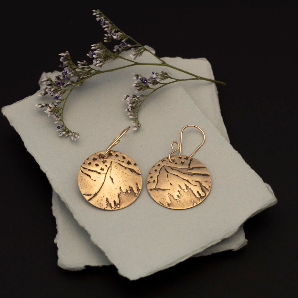 Brass mountain and stars earrings with impressed night-sky landscape, 14k gold-filled ear wires, and 1 3/8 inch length, handmade by Divella Designs in Vermont.
