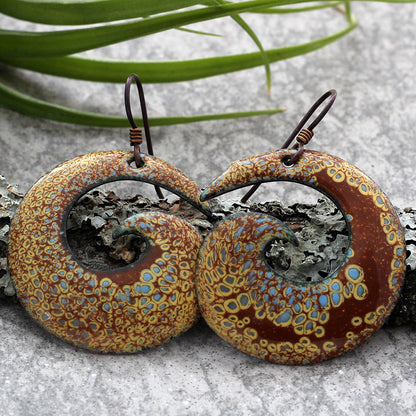 Brown and blue enamel spiral earrings with botanical pattern and niobium ear wires