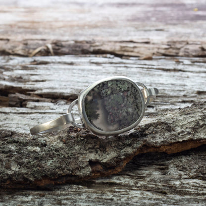 Sterling silver tension cuff with dendritic agate resembling a miniature landscape