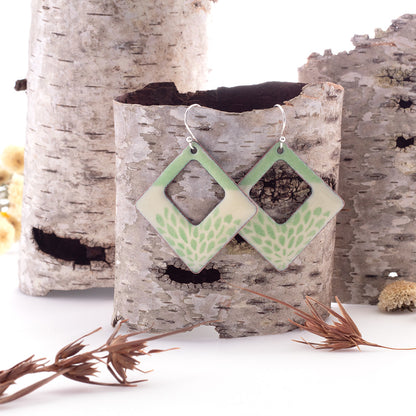 Pale green enamel square earrings with floral pattern and open window design on copper, sterling silver ear wires