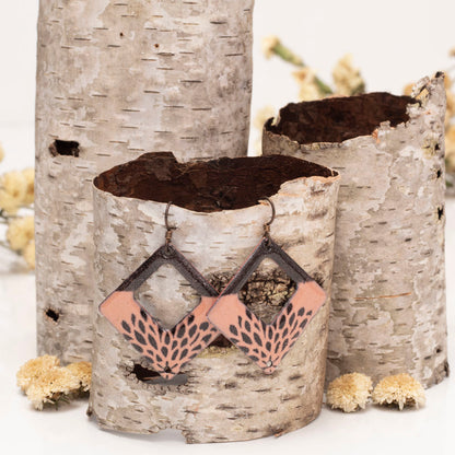 Geometric pink enamel earrings with black petal print on square copper frames