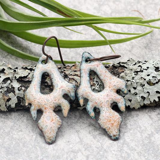 Pale enamel flame-shaped earrings with organic patterns and niobium ear wires