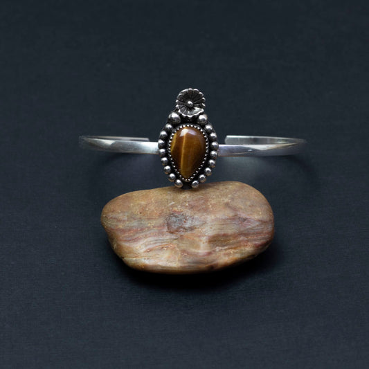 Sterling silver cuff bracelet with tiger’s eye cabochon in floral and beaded setting, handmade jewelry