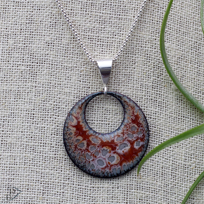 Swirled enamel pendant with fossil-inspired texture and sterling silver bail