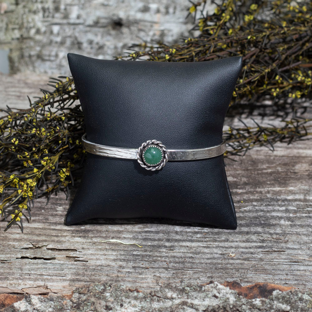 Green aventurine sterling silver cuff bracelet with fine silver setting, twisted silver border, and 2.5 inch inside diameter, handmade by Divella Designs in Vermont.