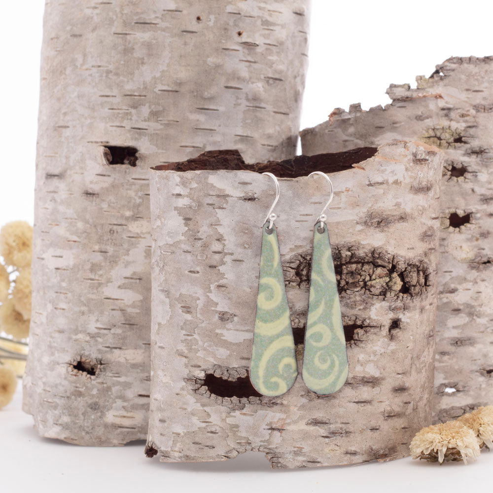 Pale green enamel dangle earrings with soft cream swirls and sterling silver ear wires