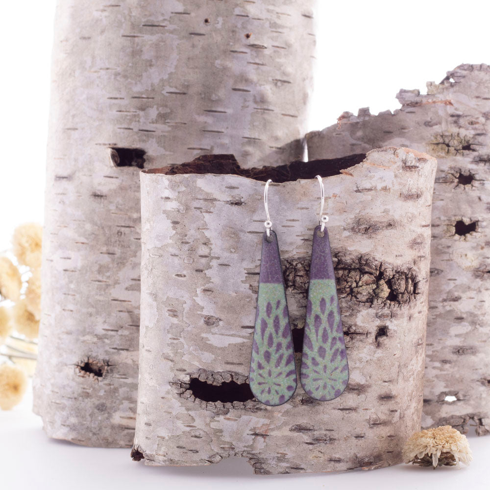 Handmade enamel drop earrings in deep plum and sage green with botanical pattern, sterling silver ear wires.