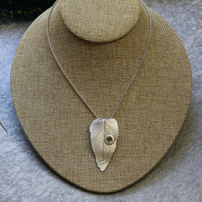 Sterling silver leaf pendant with gemstone detail on 20-inch chain