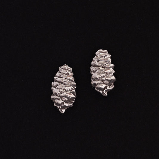 Sterling silver pinecone stud earrings with detailed texture, nature-inspired handmade jewelry