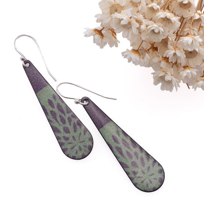 Handmade enamel drop earrings in deep plum and sage green with botanical pattern, sterling silver ear wires.