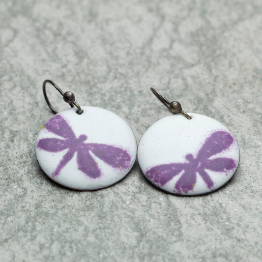 White kiln-fired enamel earrings with purple dragonflies and niobium ear wires