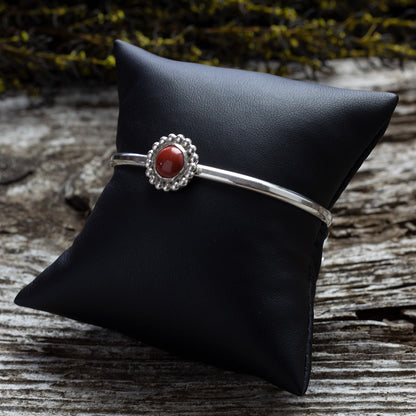 Sterling silver cuff bracelet with red jasper cabochon and beaded floral bezel, handmade jewelry