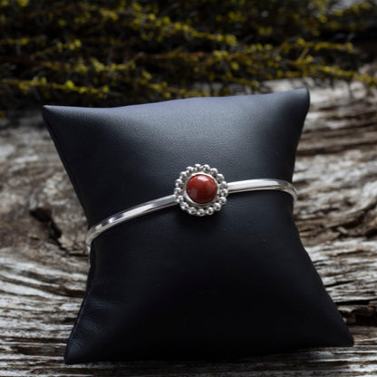 Sterling silver cuff bracelet with red jasper cabochon and beaded floral bezel, handmade jewelry