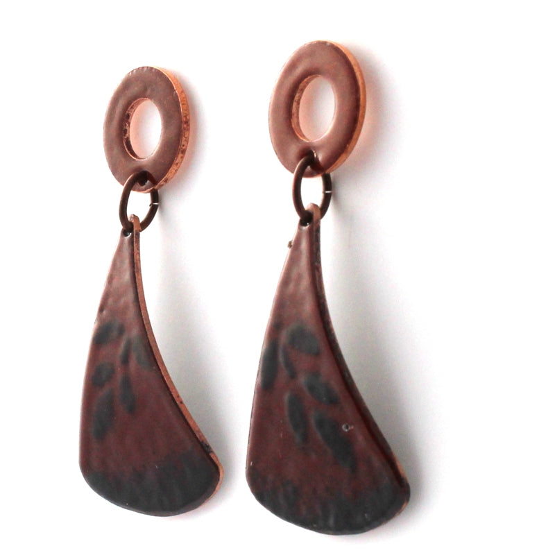 Red and black kiln-fired enamel earrings on copper with circular tops and surgical steel posts, handmade by Divella Designs in Vermont.