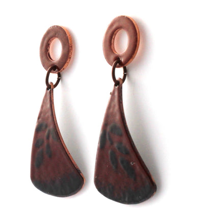 Red and black kiln-fired enamel earrings on copper with circular tops and surgical steel posts, handmade by Divella Designs in Vermont.