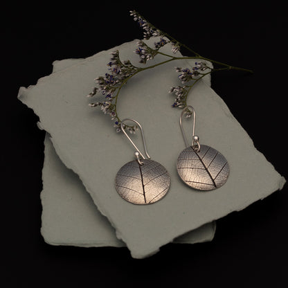 Sterling silver earrings with real leaf pattern and round disc shape