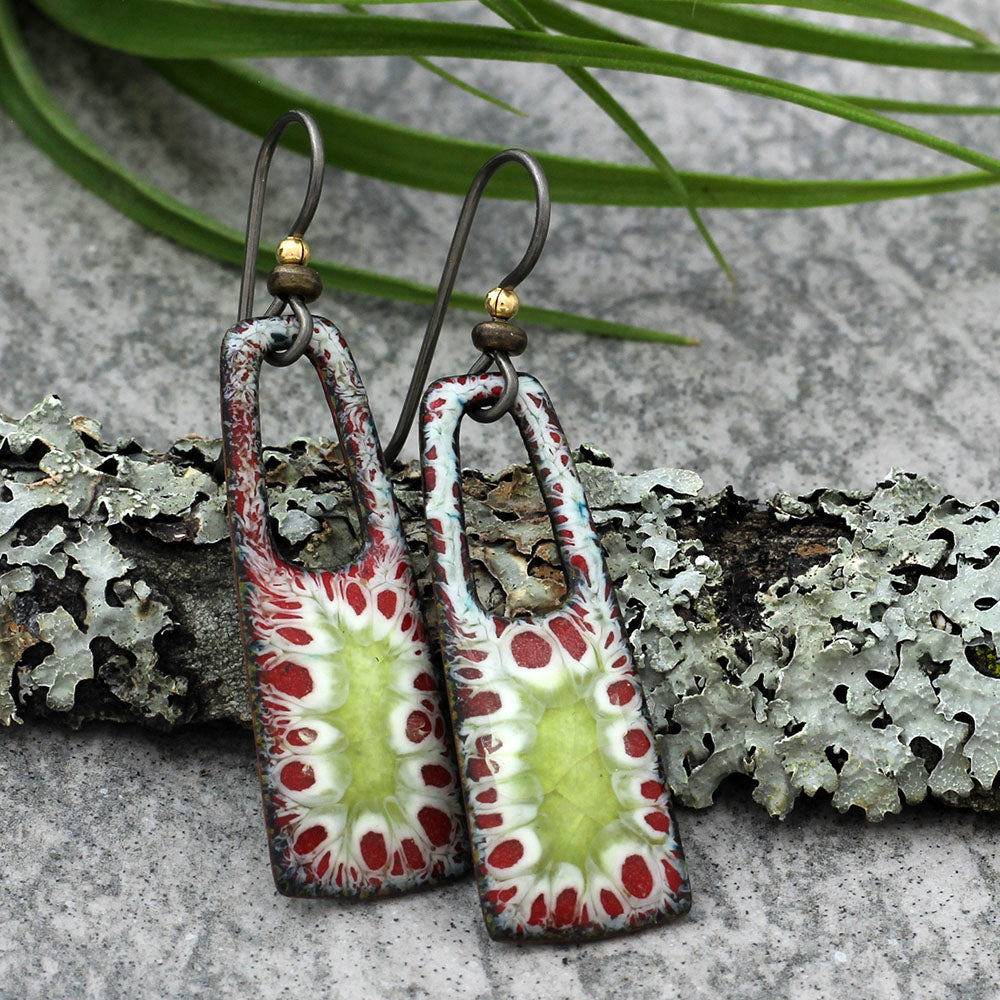 Enamel earrings with red, green, and white organic burst pattern and niobium ear wires