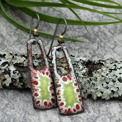 Enamel earrings with red, green, and white organic burst pattern and niobium ear wires
