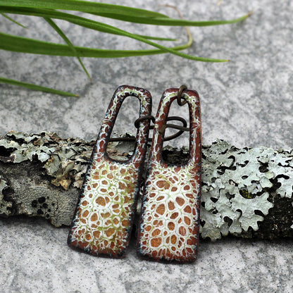 Enamel earrings with rust, ivory, and mossy green organic pattern and niobium ear wires