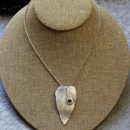 Sterling silver leaf pendant with gemstone detail on 20-inch chain