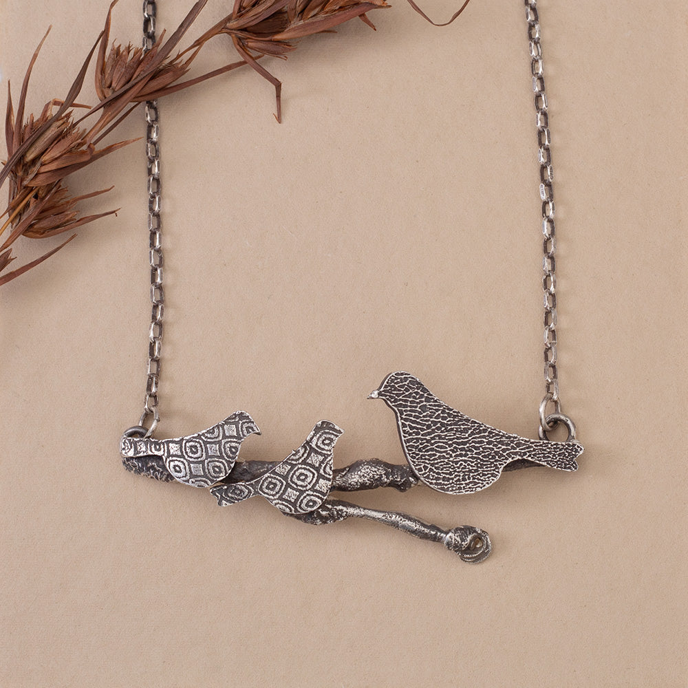 Sterling silver Storytime necklace inspired by twin granddaughters and nature, with a 2 3/4 inch wide pendant on an 18 inch oxidized sterling silver chain.