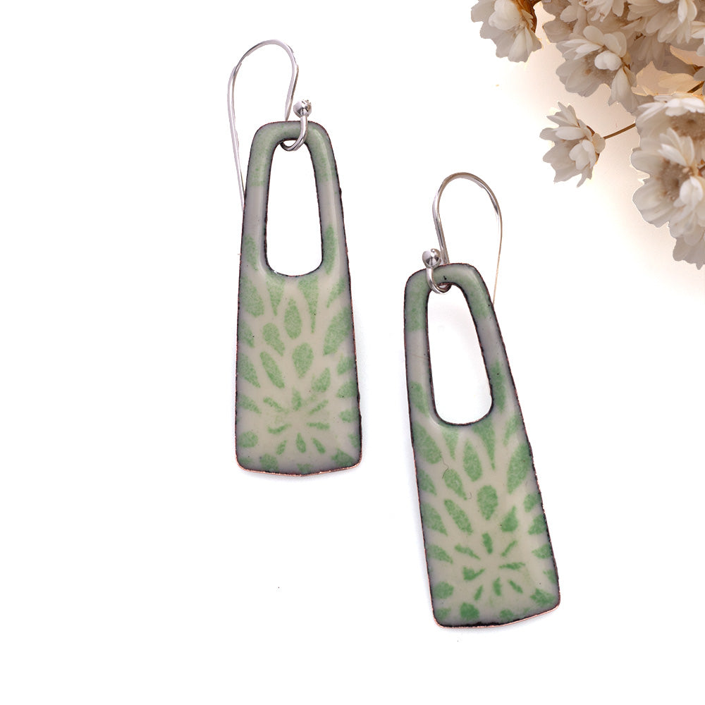 Pale green enamel rectangle earrings with floral pattern and open window design on copper, sterling silver ear wires.