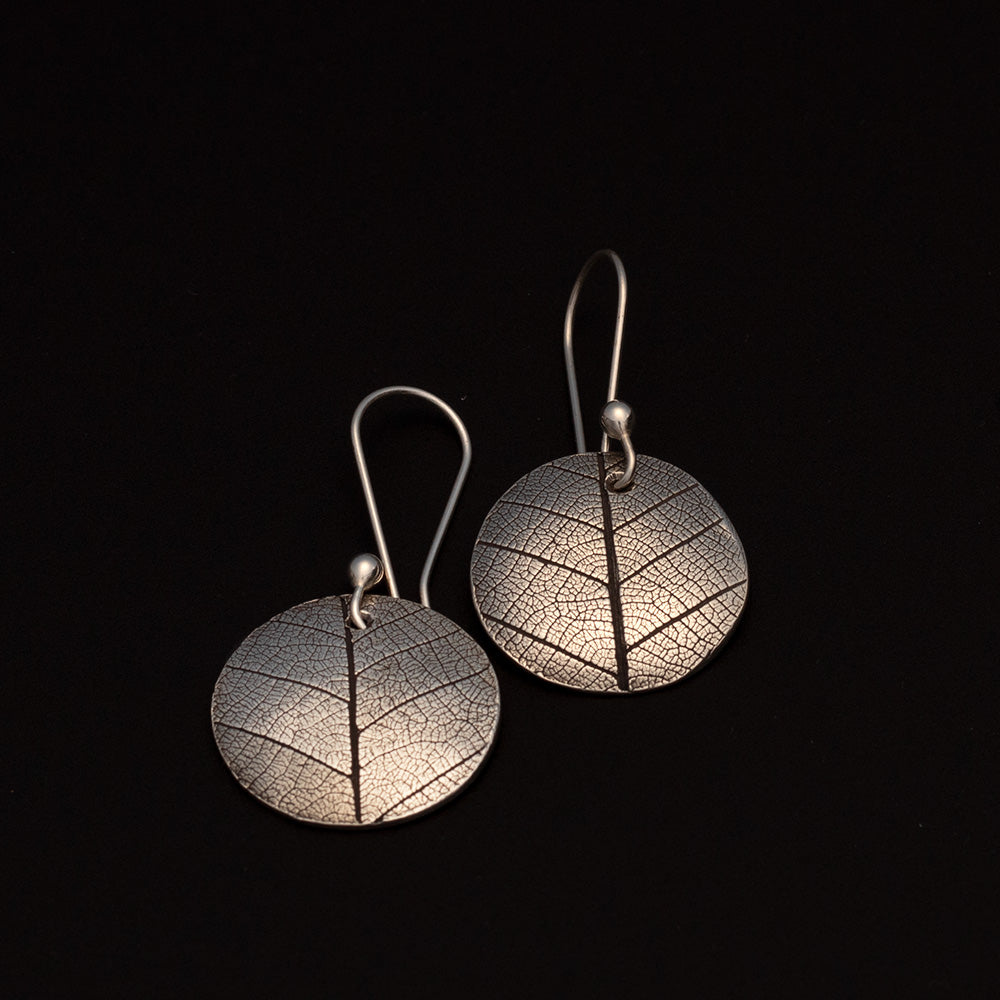 Sterling silver earrings with real leaf pattern and round disc shape
