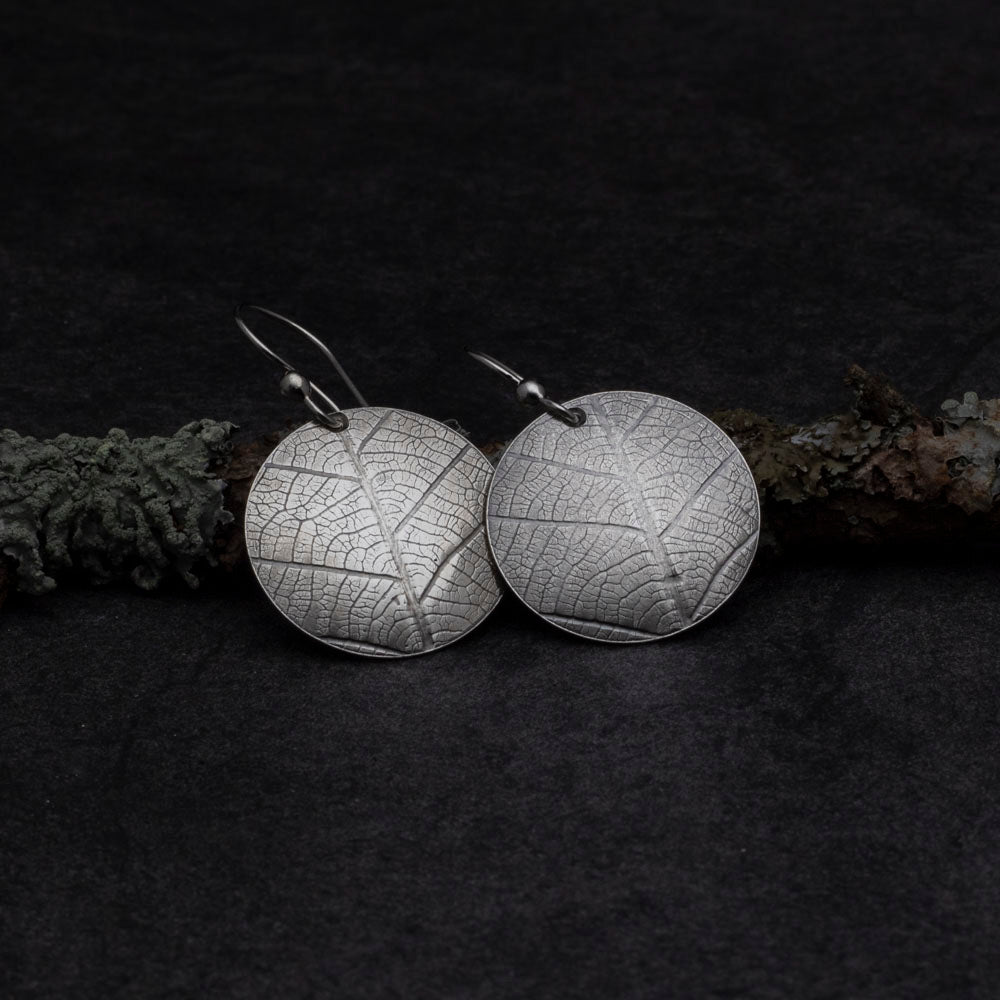 Sterling silver earrings with real leaf pattern and round disc shape