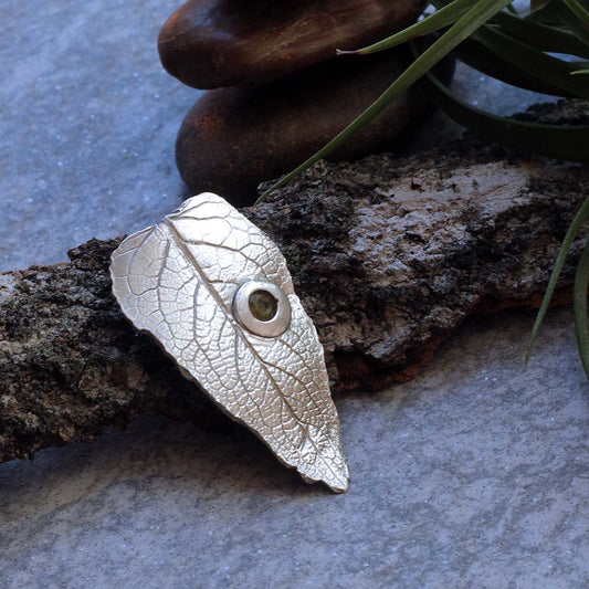 Sterling silver leaf pendant with gemstone detail on 20-inch chain