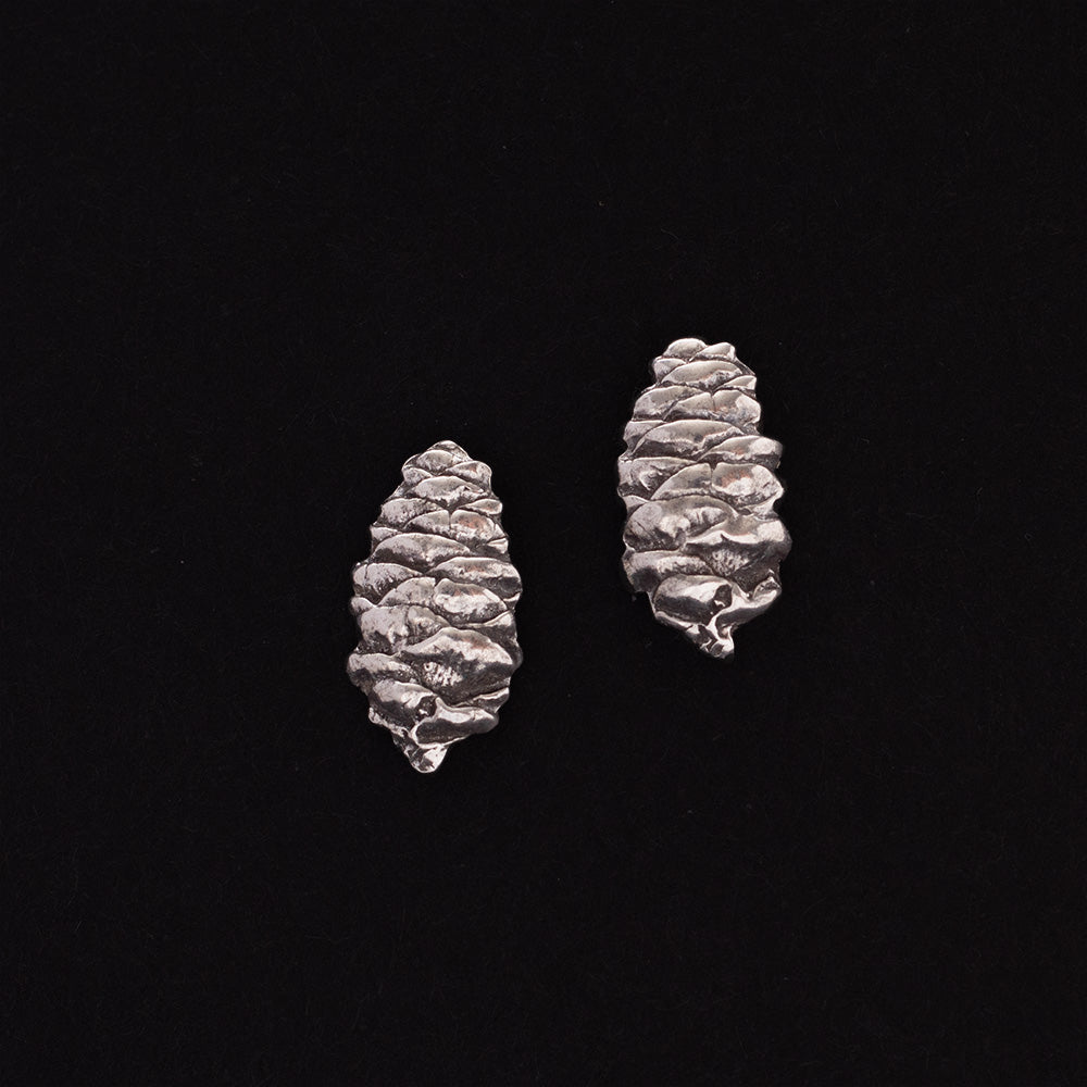 Sterling silver pinecone stud earrings with detailed texture, nature-inspired handmade jewelry