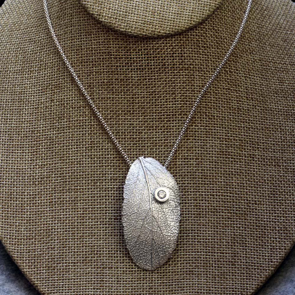 Sterling silver sage leaf necklace with small gemstone accent on an 18 inch chain, handmade by Divella Designs in Vermont.