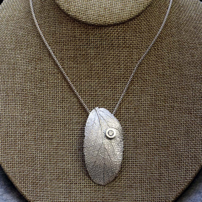 Sterling silver sage leaf necklace with small gemstone accent on an 18 inch chain, handmade by Divella Designs in Vermont.